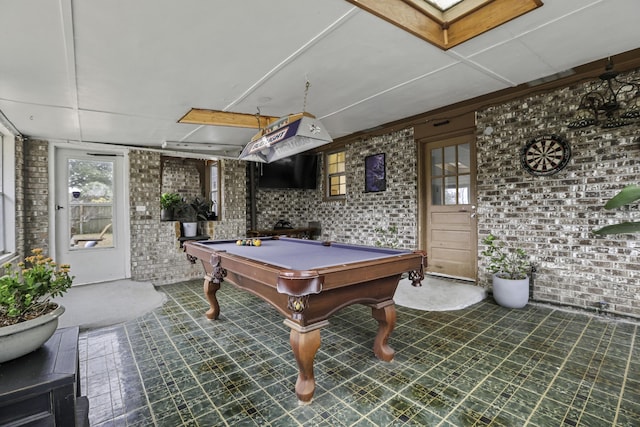 rec room with brick wall and billiards