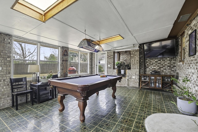 playroom with brick wall and pool table