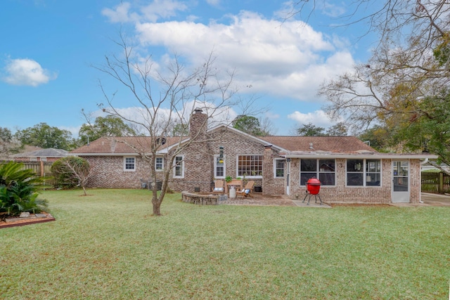 rear view of property with a patio area and a lawn