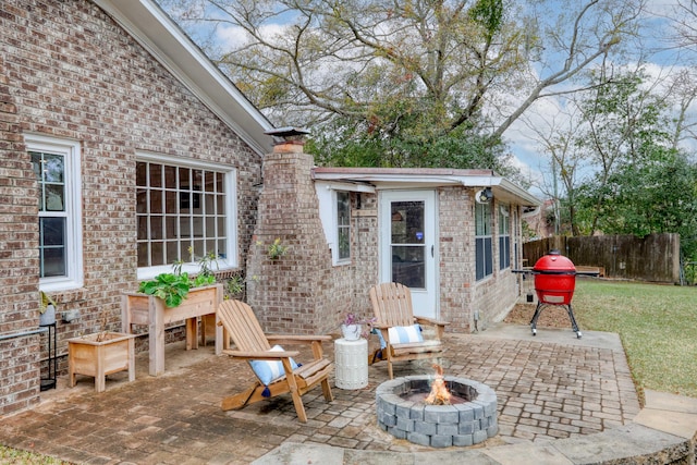 view of patio featuring an outdoor fire pit and an outdoor structure