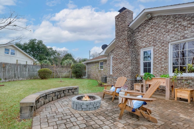 view of patio with central air condition unit and an outdoor fire pit