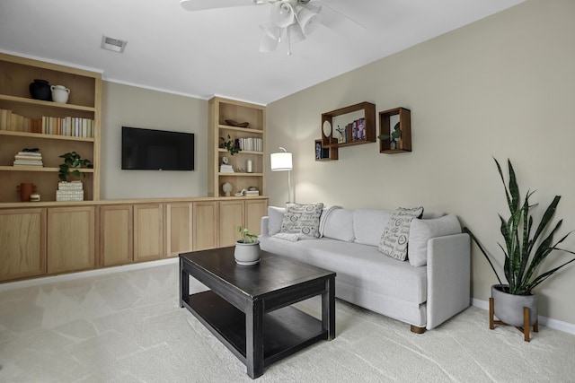 carpeted living room with ceiling fan