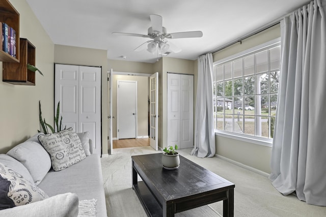 living room with light carpet and ceiling fan