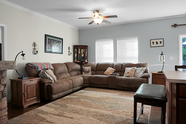 living room with dark hardwood / wood-style flooring, ceiling fan, and ornamental molding