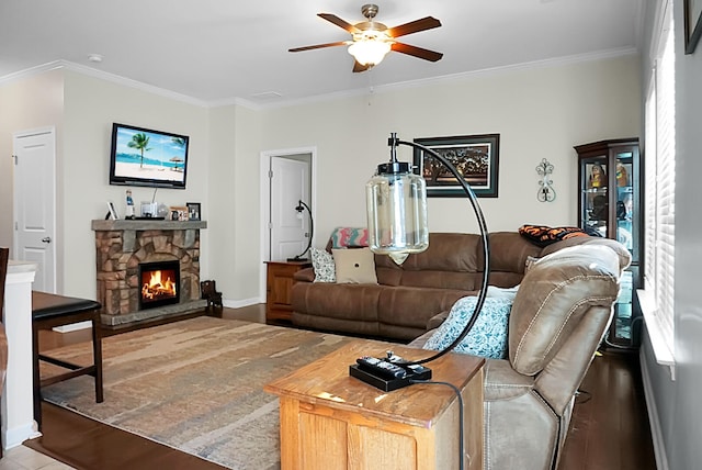 living room featuring a fireplace, hardwood / wood-style floors, plenty of natural light, and ornamental molding