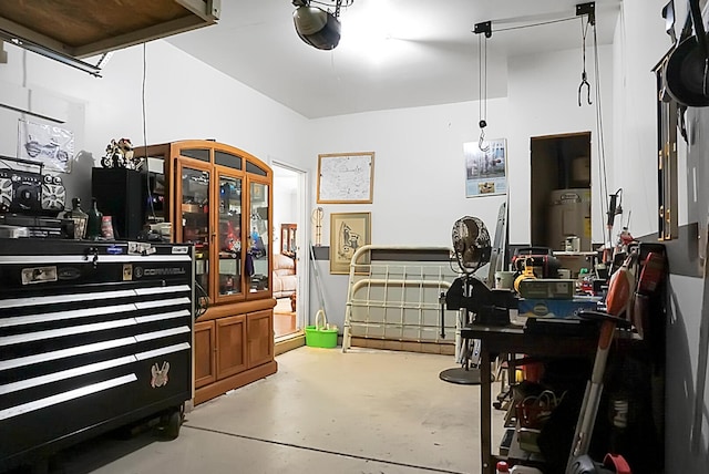 miscellaneous room featuring water heater and concrete flooring