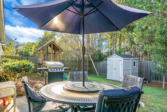 view of patio / terrace featuring a playground and a storage shed