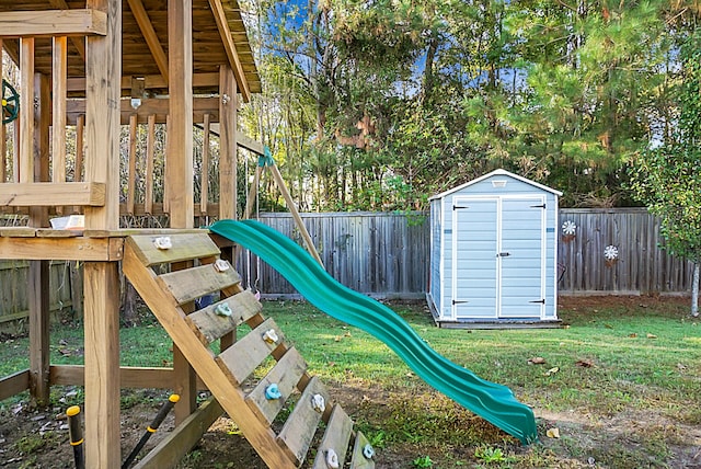 view of play area with a yard and a storage shed