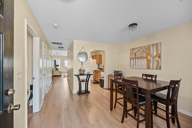 dining room with light wood-type flooring