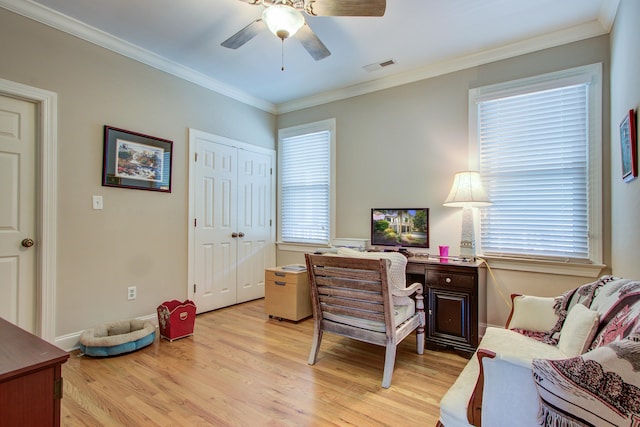 office featuring visible vents, light wood-style flooring, ceiling fan, and a wealth of natural light