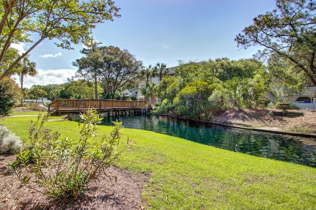 view of yard with a deck with water view