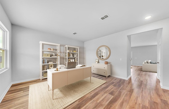 home office with recessed lighting, visible vents, baseboards, and light wood-style flooring