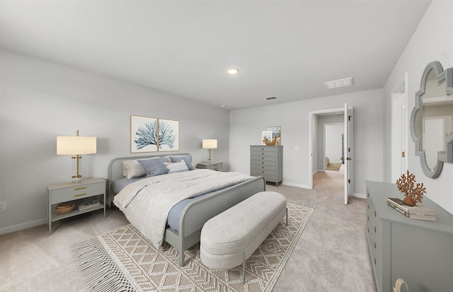 bedroom with visible vents, light carpet, and baseboards