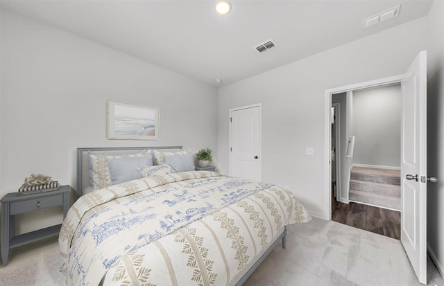 carpeted bedroom with visible vents and baseboards