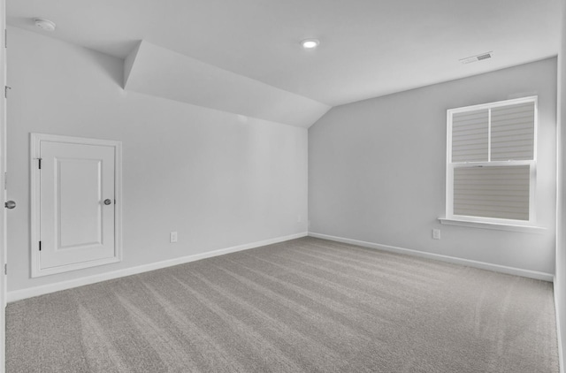 bonus room with lofted ceiling, carpet flooring, and baseboards