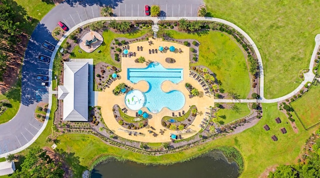 aerial view of a pool area and a nearby body of water