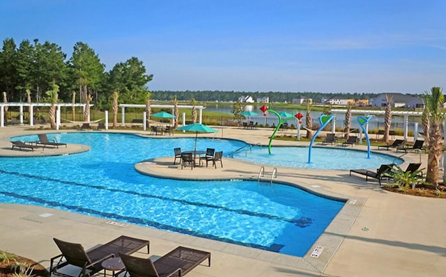 community pool featuring a patio area and fence