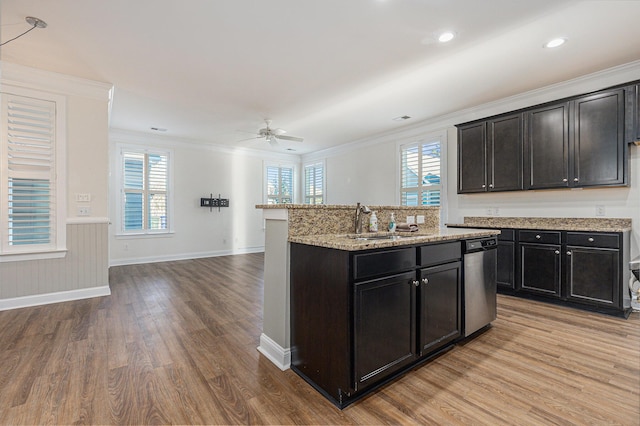 kitchen featuring sink, wood-type flooring, stainless steel dishwasher, and crown molding