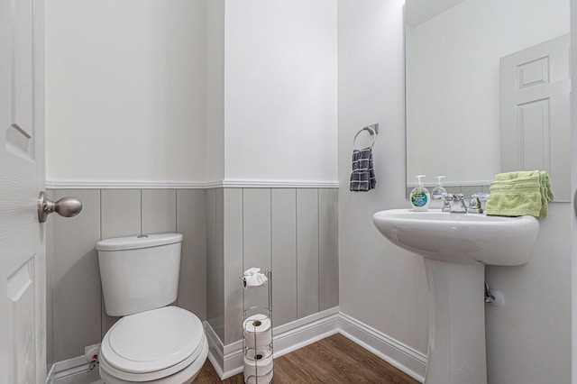 bathroom with toilet and hardwood / wood-style floors