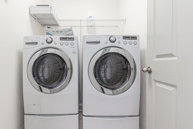 clothes washing area featuring separate washer and dryer