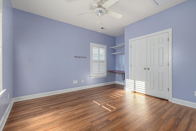 unfurnished bedroom featuring dark wood-type flooring, a closet, and ceiling fan