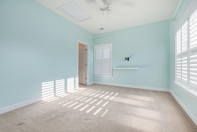 spare room with light colored carpet and ceiling fan