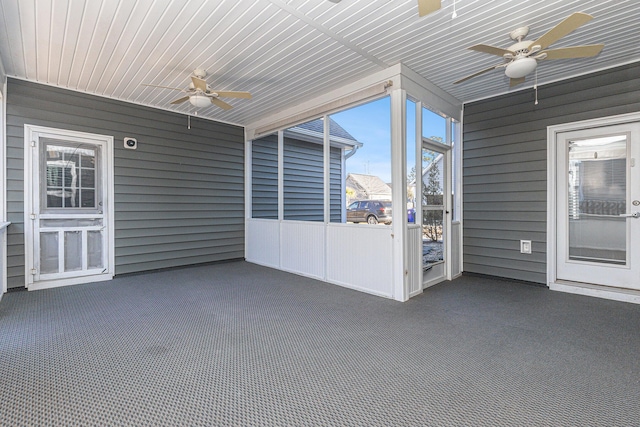 unfurnished sunroom with ceiling fan