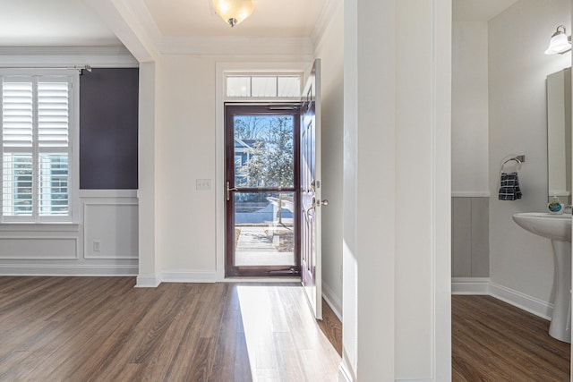 entrance foyer with plenty of natural light, dark hardwood / wood-style flooring, and ornamental molding