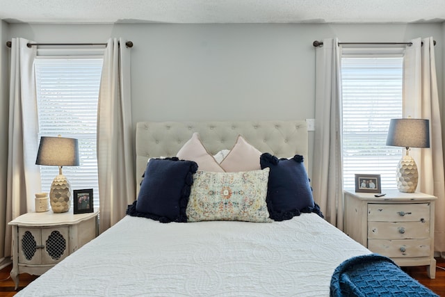 bedroom featuring a textured ceiling and dark wood-type flooring