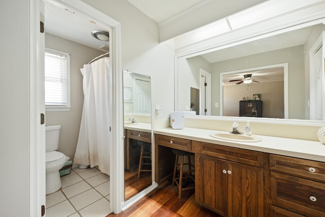 bathroom featuring ceiling fan, tile patterned flooring, vanity, and toilet