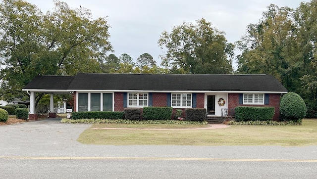 ranch-style house with a front lawn