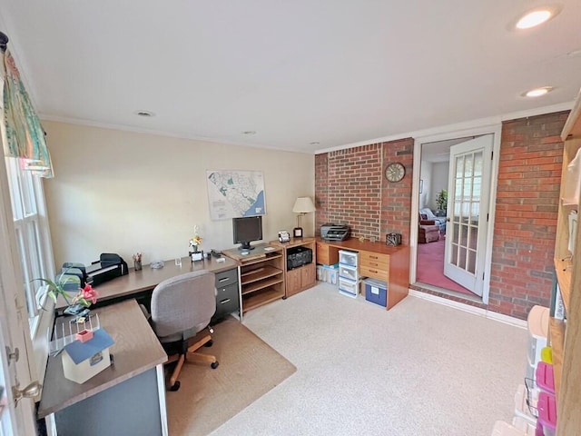 carpeted office space with french doors and brick wall