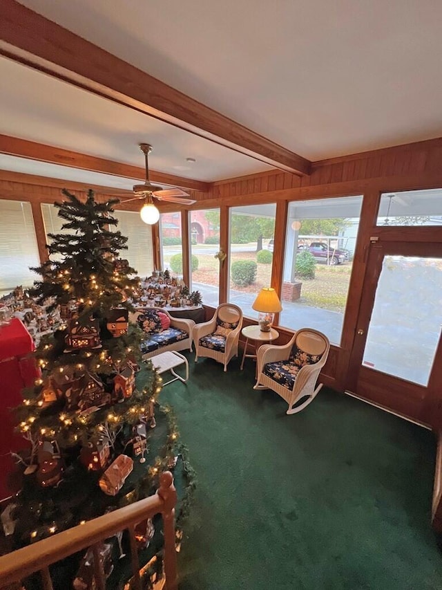 unfurnished sunroom with beam ceiling and ceiling fan