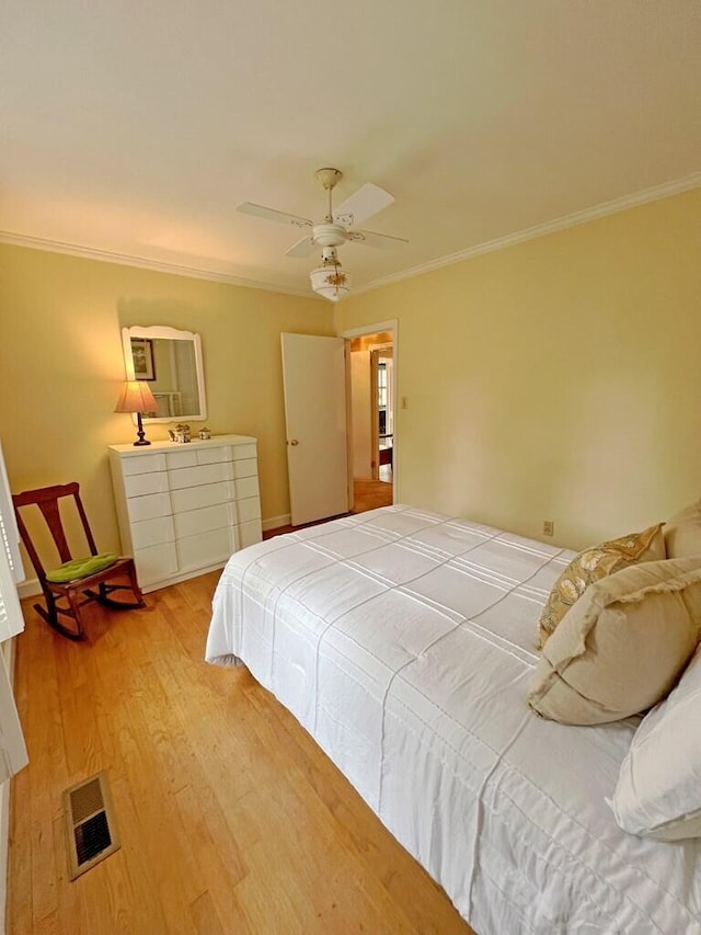 bedroom with ceiling fan, light hardwood / wood-style flooring, and ornamental molding