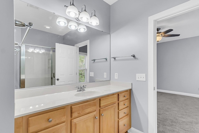 bathroom featuring vanity, baseboards, a stall shower, and a ceiling fan