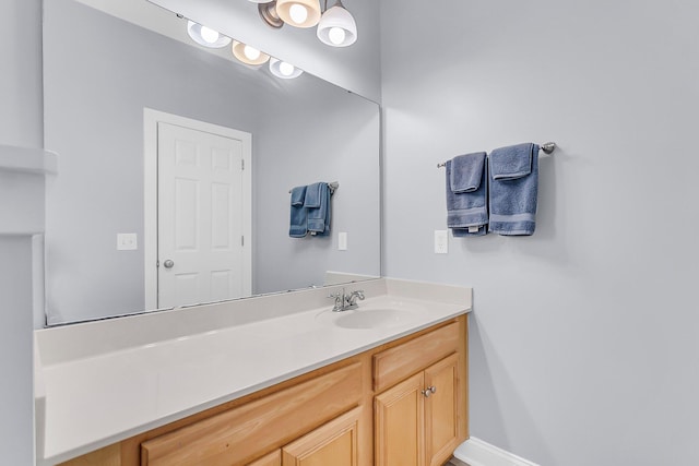 bathroom with baseboards and vanity