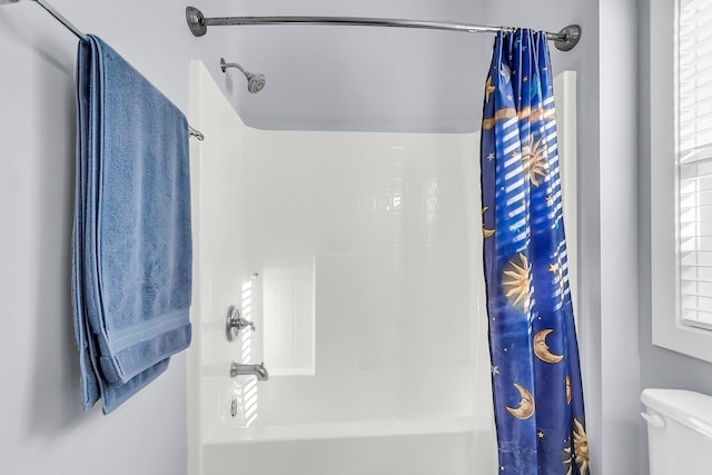 full bathroom featuring shower / bath combination with curtain and toilet