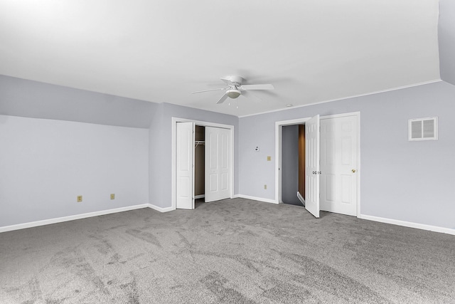 unfurnished bedroom with a ceiling fan, baseboards, visible vents, lofted ceiling, and carpet flooring