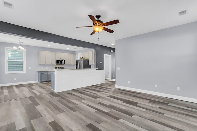 kitchen featuring visible vents, baseboards, and appliances with stainless steel finishes