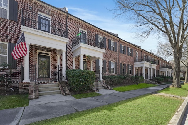 townhome / multi-family property with brick siding