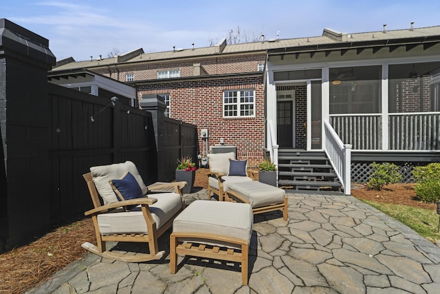 view of patio featuring fence private yard and a sunroom