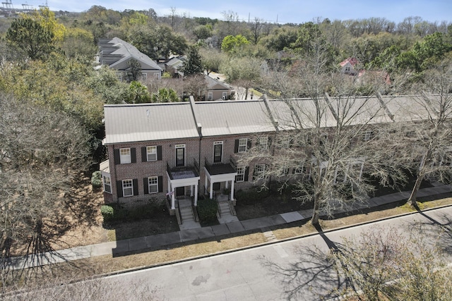 view of front facade with fence and brick siding