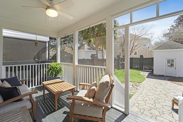 sunroom / solarium featuring a ceiling fan