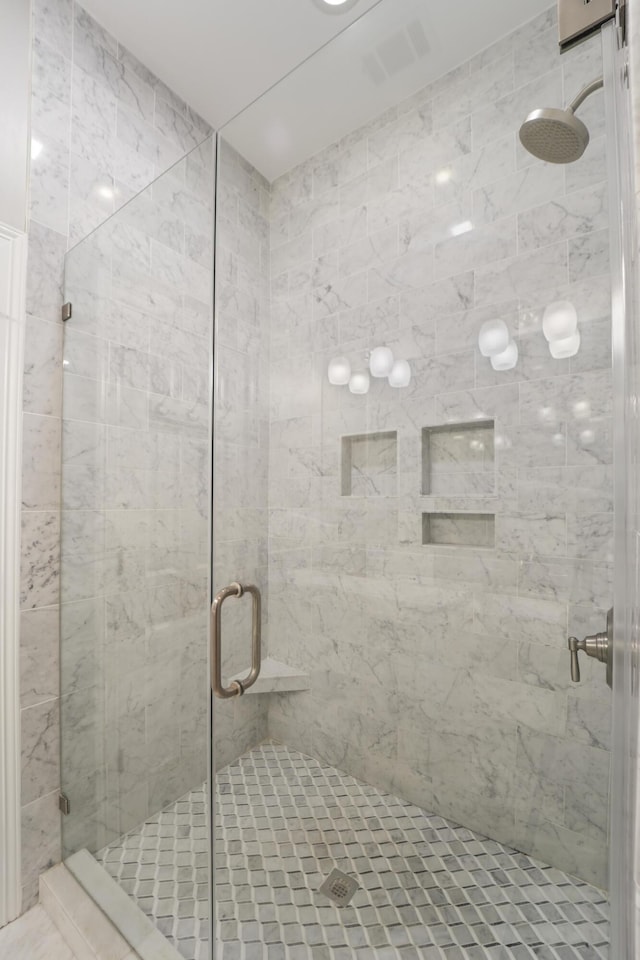 full bath with visible vents and a stall shower