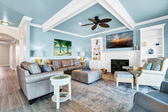 1404 Palmetto Blvd, Edisto Beach, SC 29438 - living room with beam ceiling, a fireplace, crown molding, ceiling fan, and arched walkways
