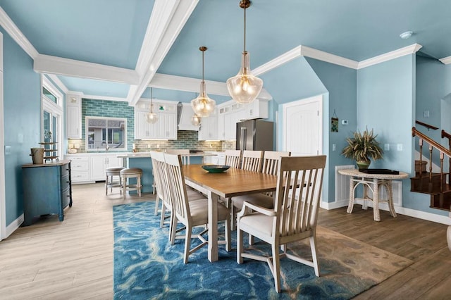 1404 Palmetto Blvd, Edisto Beach, SC 29438 - dining area with baseboards, stairs, ornamental molding, and light wood-style flooring