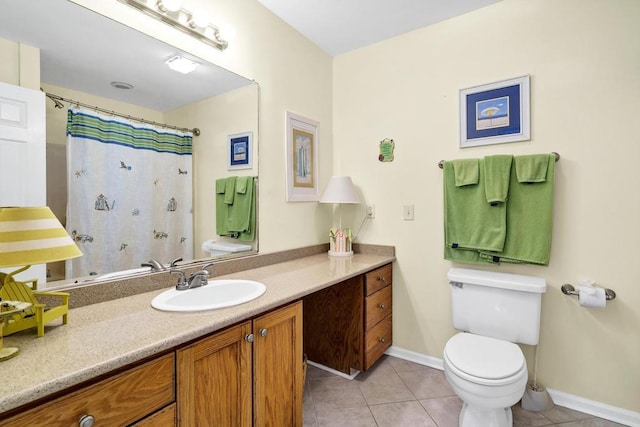 1404 Palmetto Blvd, Edisto Beach, SC 29438 - bathroom featuring toilet, baseboards, tile patterned flooring, and vanity