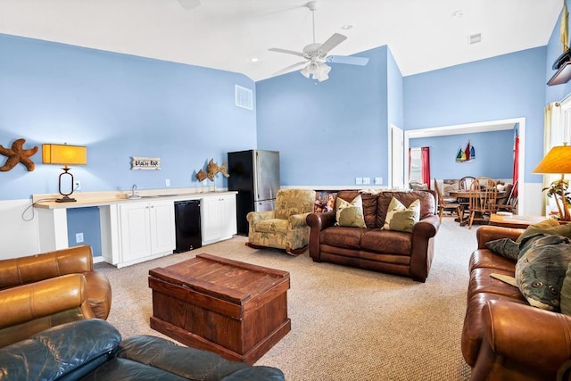 1404 Palmetto Blvd, Edisto Beach, SC 29438 - living room featuring a ceiling fan, light colored carpet, high vaulted ceiling, and visible vents