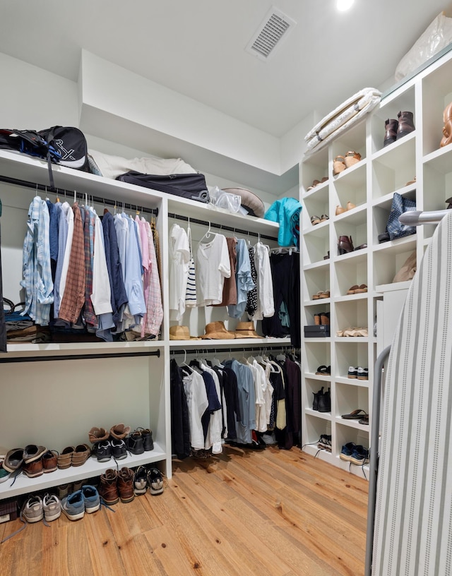 walk in closet with wood finished floors and visible vents