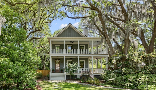 exterior space featuring ceiling fan, a balcony, covered porch, and board and batten siding